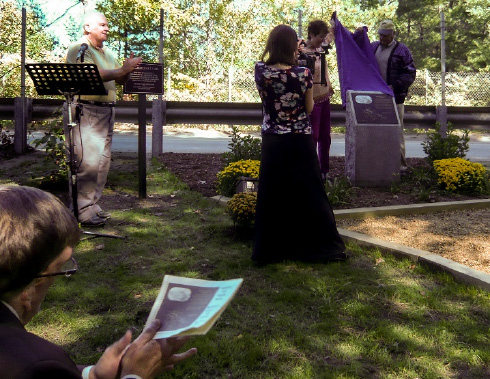 Mr. John Curran in foreground, Alec Ingraham at podium, Shayne Reardon and Stuart Potter, Jr. unveiling marker, and Nancy Albertson filming for BATV