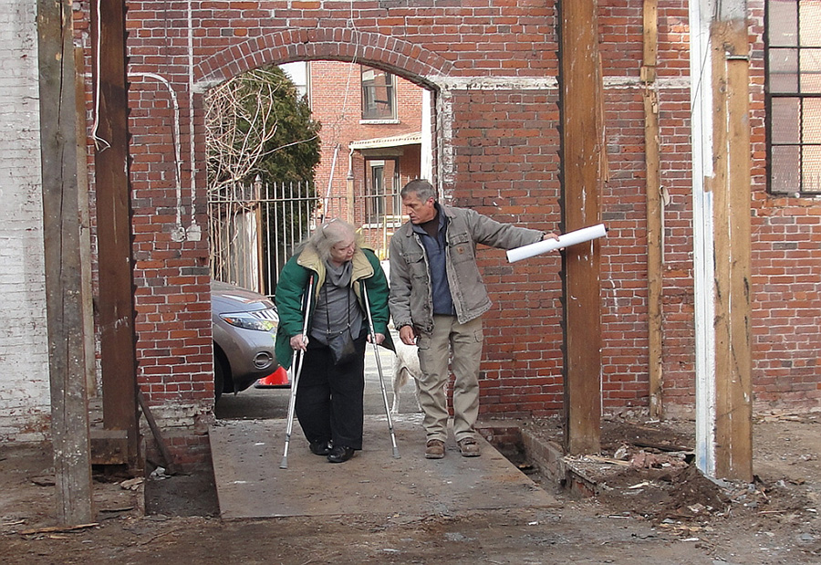 Betty Bigwood and general contractor Bill Cogley in doorway